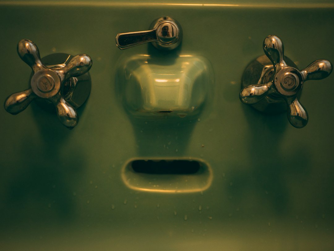 Close-up of a sink and water supply fittings checked for a leak