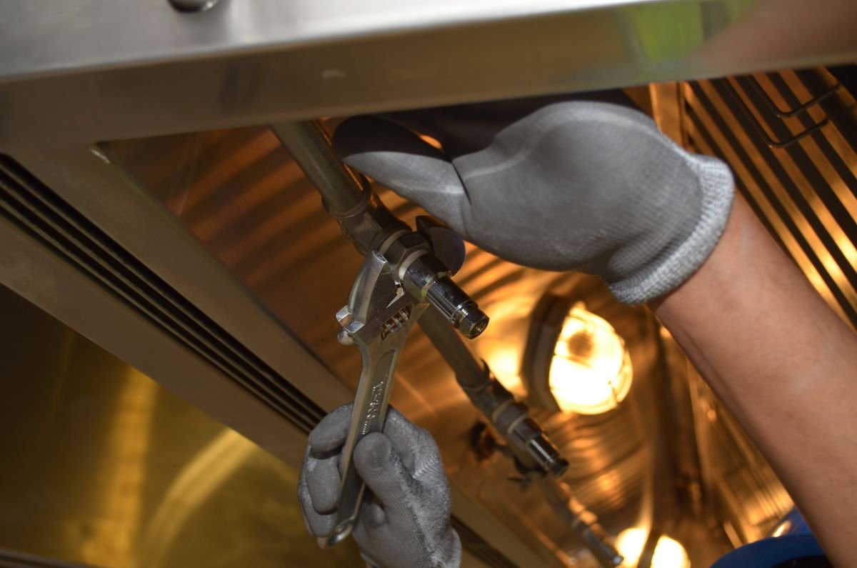 Plumber in Esher repairing pipework