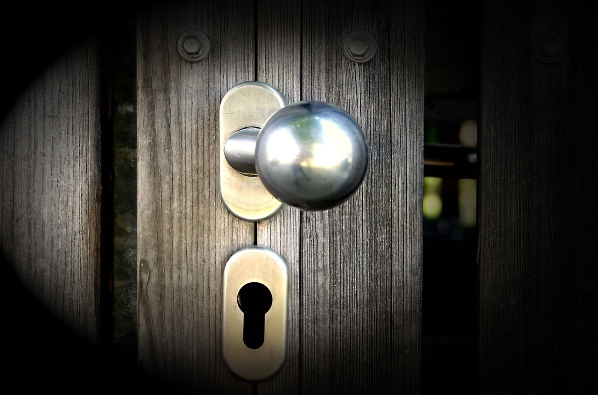 Locksmith in Wimbledon fitting a door lock