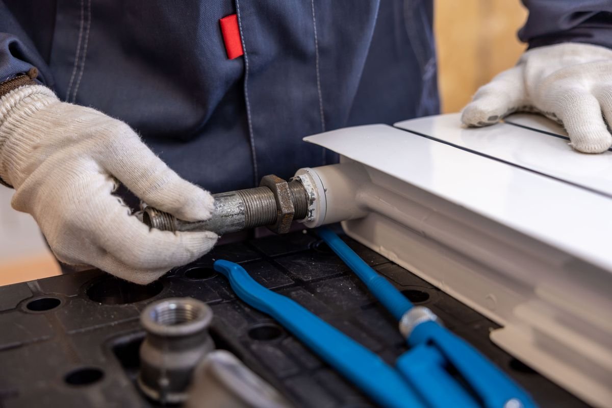 Plumber in Chiswick repairing pipework
