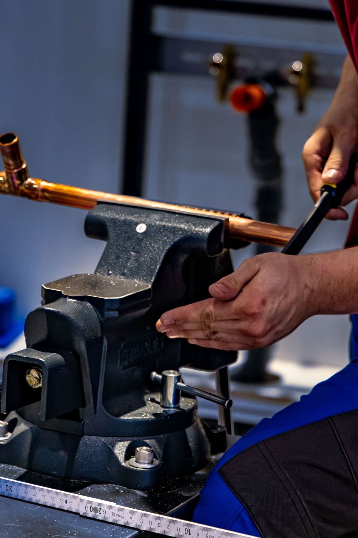 Plumber in Cobham repairing pipework