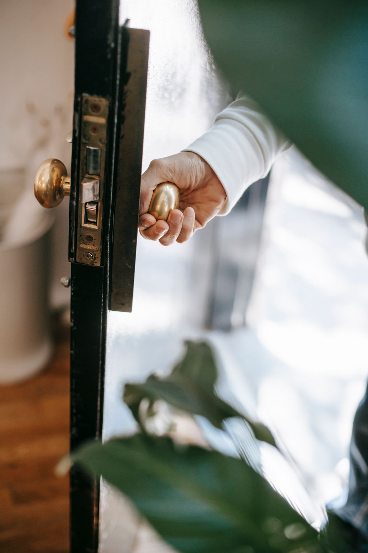 A locksmith opening a locked front door without damaging the lock