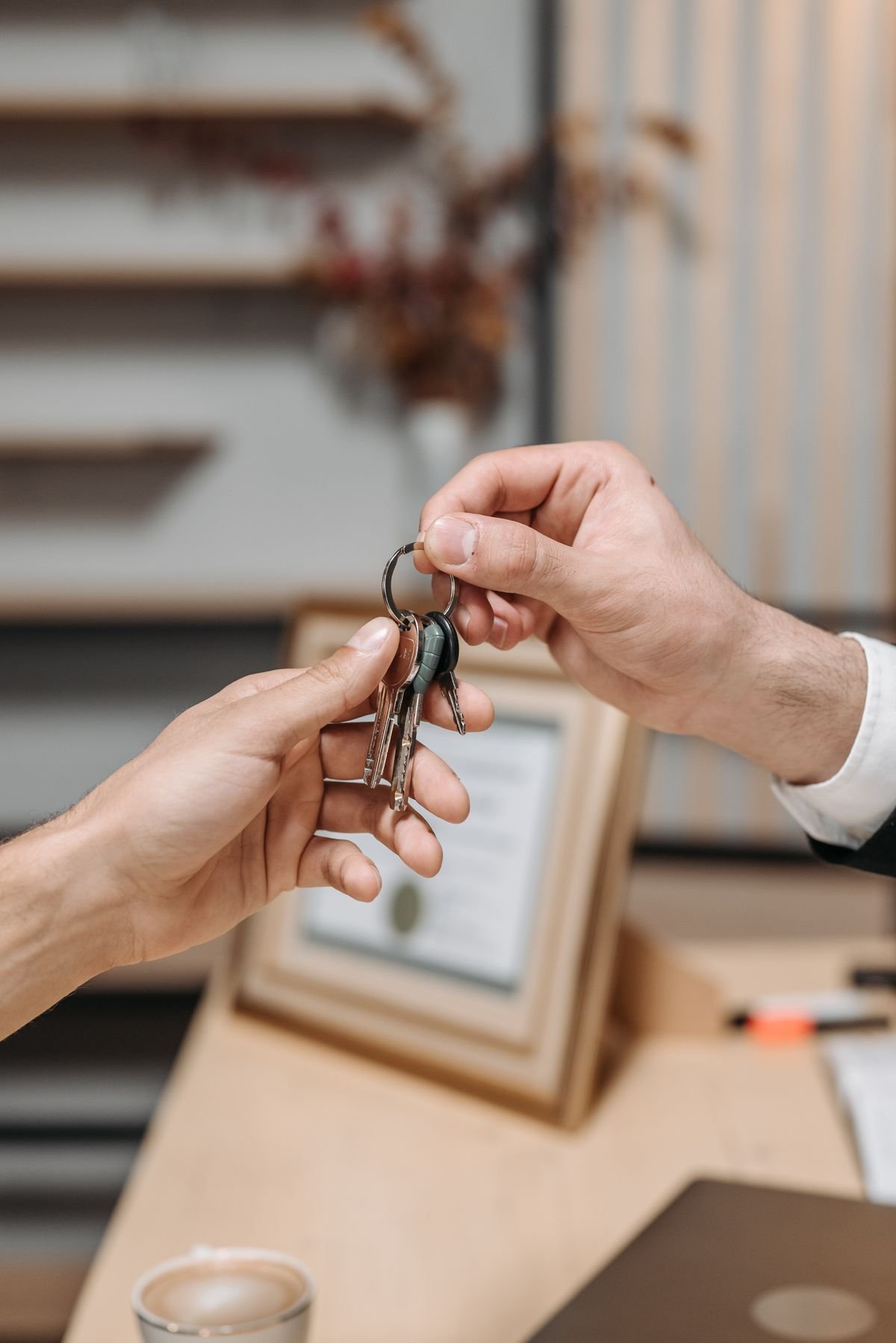 A close-up of a new front door lock and set of keys being handed over on moving day