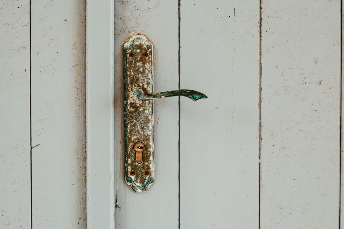 uPVC window lock repair - locksmith servicing a window lock with a tool roll in London